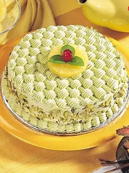 This pistachio and pineapple cake showcases detailed basketweave piping, giving it a unique and sophisticated look. The combination of nutty pistachio and sweet pineapple creates a truly special flavour profile.