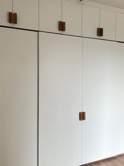 This image shows how our custom wardrobes can be designed to fit any room layout, including corners and varying wall lengths, for a truly built-in feel.