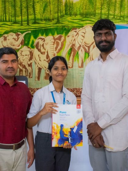 A student receives her ABRSM piano exam book, ready for her examination.