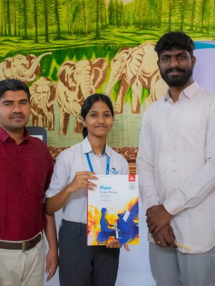 A student receives her ABRSM piano exam book, ready for her examination.