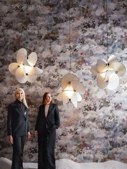 Designers Sofia Lagerkvist and Anna Lindgren of Front with their Serpentine Lights. Their design process involved discovering the limits of how paper could be twisted and shaped to create this flowing form.