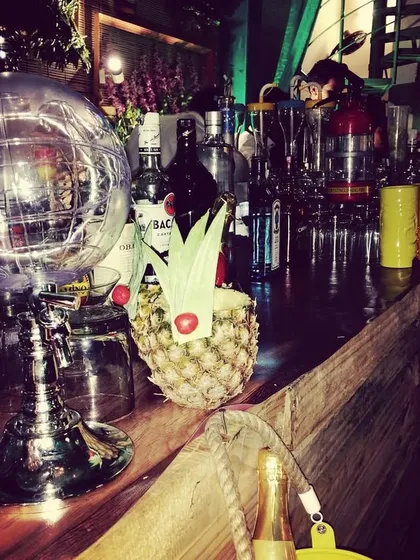 A view of our bar setup featuring a variety of our unique serving vessels, including a disco ball glass and a cocktail served in a pineapple.