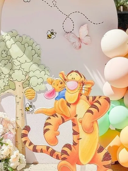 Tigger and Piglet join the party in this close-up of the vibrant, character-filled baby shower decor.