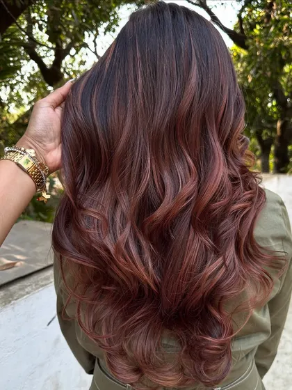 A 'Rose Gold' dream come true. We transformed her faded highlights into this stunning metallic pink shade. It’s a trendy yet sophisticated way to play with color.