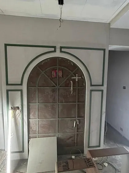 During construction: The framework for the grand arched mirror wall in the dining room takes shape. This shows the structural work behind the final look.
