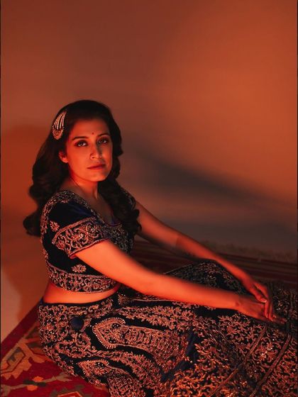 A seated portrait from a 40th birthday shoot, with warm lighting creating an intimate and celebratory atmosphere.