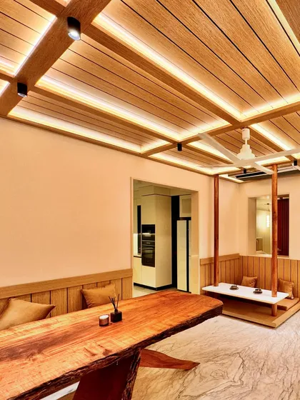 I designed this Zen-inspired dining area to be a space for connection and tranquility. The centerpiece is a live-edge wooden table, preserving the natural form of the tree. To create a unique, intimate setting, I designed a suspended bench that feels like a modern swing, encouraging a playful yet peaceful dining experience. The slatted wood ceiling with integrated lighting adds warmth and architectural rhythm.