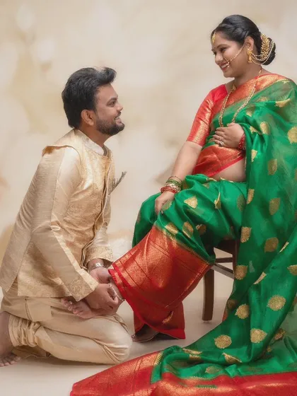 A gesture of love and respect rooted in tradition. This beautiful moment, where he tends to her, is full of tenderness. The rich colors of their outfits and the warm lighting create a truly timeless portrait.
