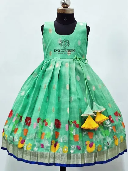 A sleeveless version of the Zari Kota frock, this one in a lovely seafoam green with a colorful bird-themed border.