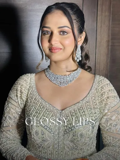 Glossy lips are in. This bride's reception look features a high-shine, glossy lip that adds a touch of modern glamour and makes her lips look full and luscious.