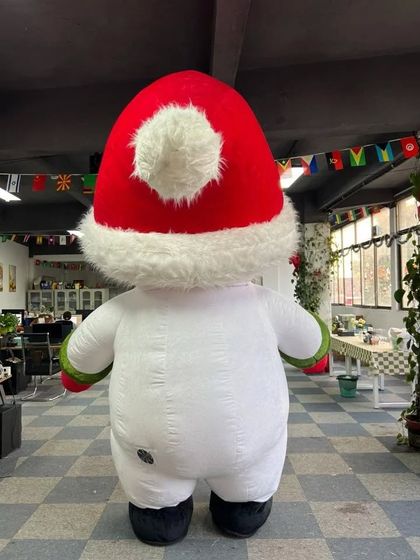 A back view of our inflatable Snowman mascot, showing off its fluffy pom-pom hat. It's a fun and friendly character from every angle.