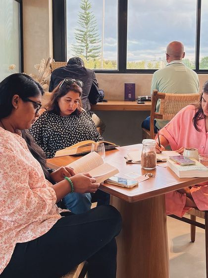 A table of readers, each lost in their own world, together. This is the simple magic of our weekly reading socials.