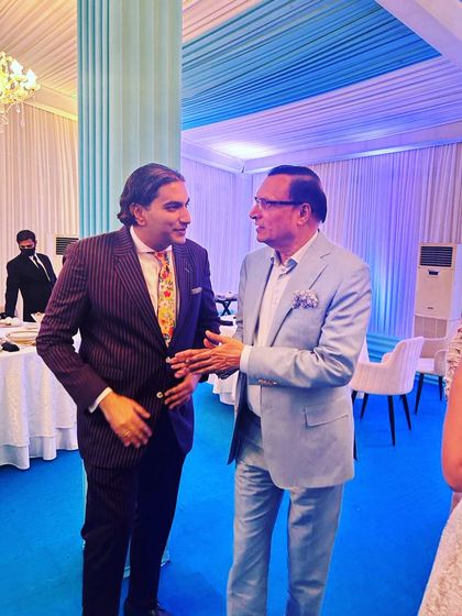 In conversation with Mr. Rajat Sharma at a wedding event. Building personal relationships with my clients is a core part of my service philosophy.