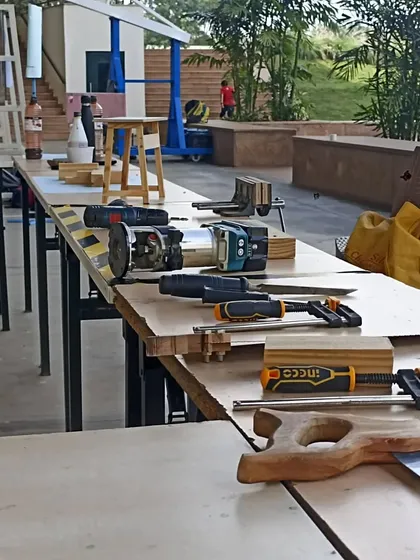A pop-up workshop setup for students. They are building adjustable-height standing desks, a project that combines woodworking with ergonomic design.