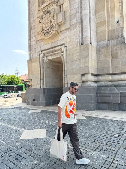 Another shot from Bucharest, showing the casual yet stylish walking outfit, complete with a practical and chic tote bag.