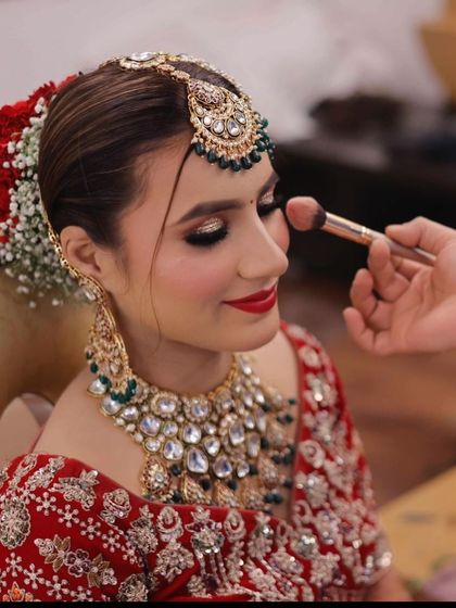 A candid shot of me applying blush. The bride's smile shows how comfortable and happy she is during the process.