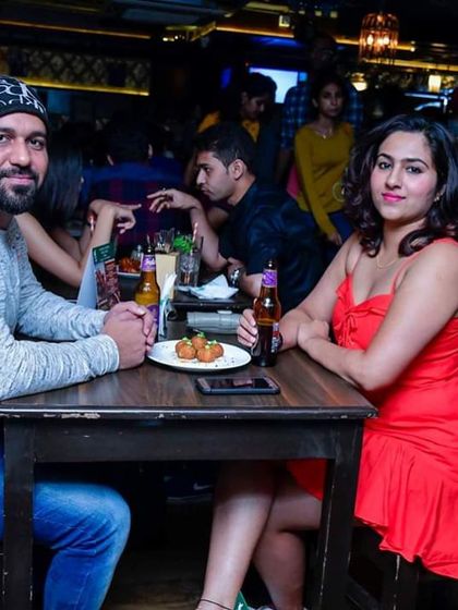 A couple enjoying drinks at their table. Even when you're taking a break from dancing, the atmosphere is always buzzing.