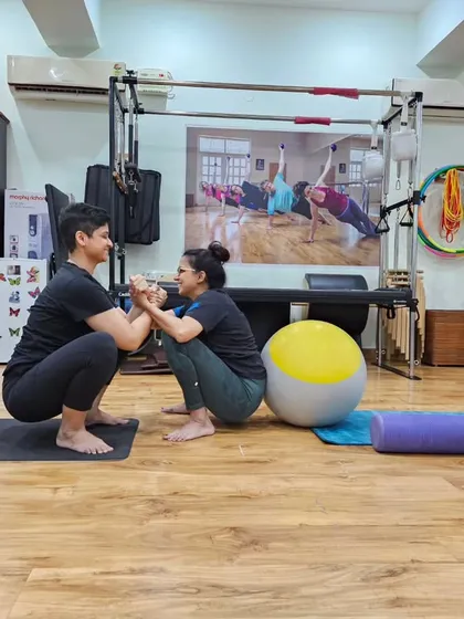 Supporting each other while going for a full squat. Partner exercises are a fun way to build strength and community.