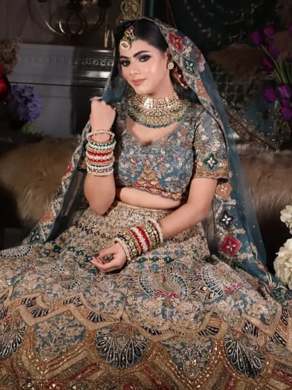 A full-length shot capturing the regal presence of the bride in her magnificent lehenga.