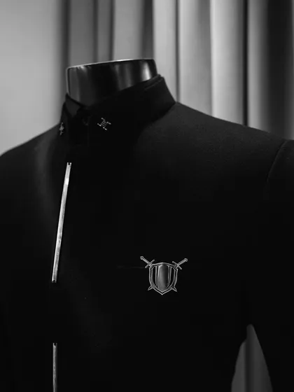 The "Metal Bling" collection is all about elevating your wardrobe with custom precision. This jacket features a shield and sword brooch, adding a touch of warrior-like elegance.