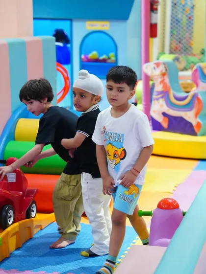 Friends exploring the play structures together during a Frozen-themed birthday adventure.