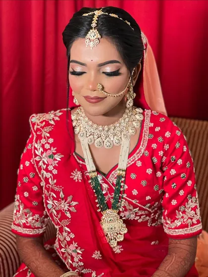 A serene portrait of the bride, looking down and showing off her beautiful eye makeup.