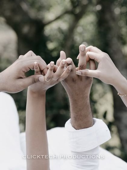 A close-up shot of the couple's hands intertwined, symbolizing their bond, during their Coorg pre-wedding shoot.