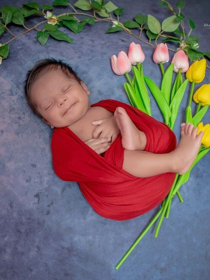 A smiling dreamer. Even in their sleep, this baby's happy expression shines through, all while being safely swaddled.