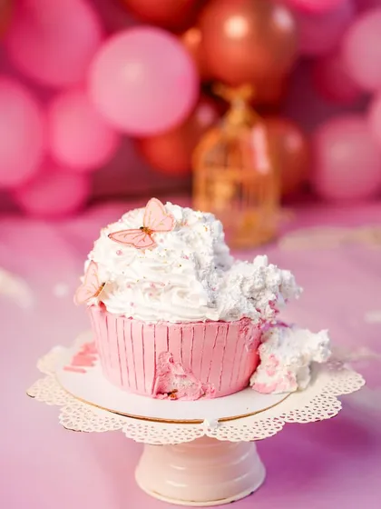 The aftermath of a delicious celebration. The beautifully smashed cupcake tells a story of fun and exploration, a perfect centerpiece for a first birthday cake smash.