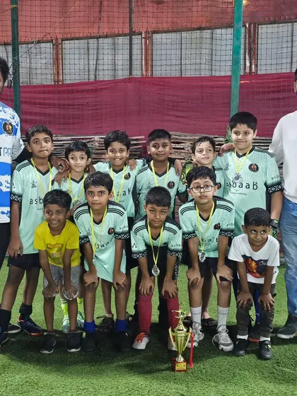 Our U11 team after being crowned champions at the Andheri Premier League, pictured with their coaches.