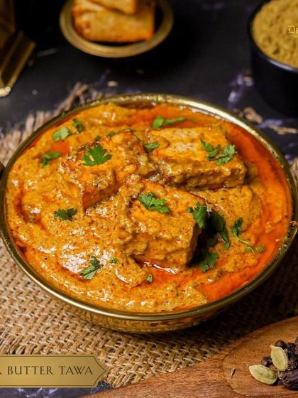 Savor the buttery goodness of our Paneer Butter Tawa. Soft paneer is cooked on a flat griddle (tawa) with a rich and creamy tomato-based sauce.