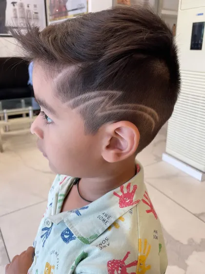 Even the little ones get a rockstar look here. I specialize in fun, creative hair art for kids, like this sharp lightning bolt design, making their haircut experience exciting and stylish.