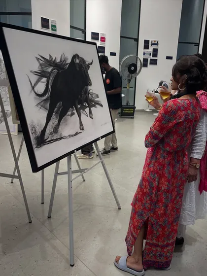 Visitors at the Hyderabad art show admiring my bull painting, 'Mighty Rush'.
