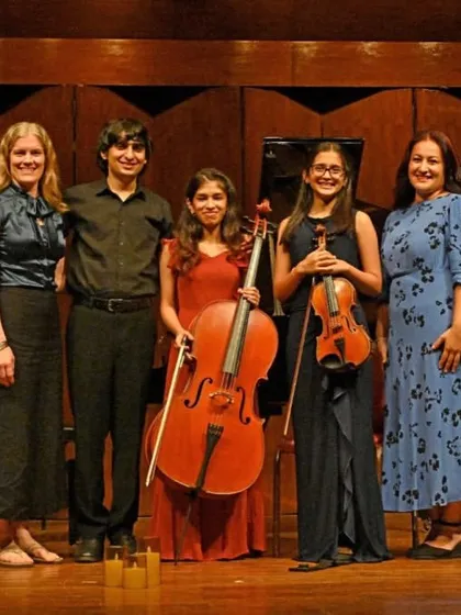 The Note Bene Trio poses with their proud teachers after a successful concert. We celebrate the strong bond between our faculty and students, which is built on mentorship and shared passion.