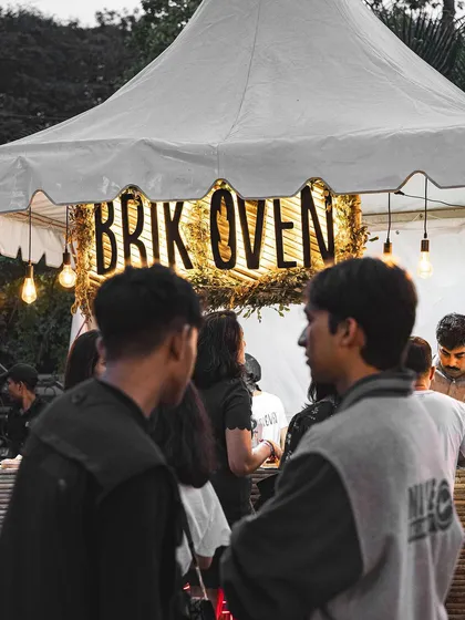 Our glowing Brik Oven stall at the Gin Explorers Club, a popular spot for festival-goers to grab a fresh slice.