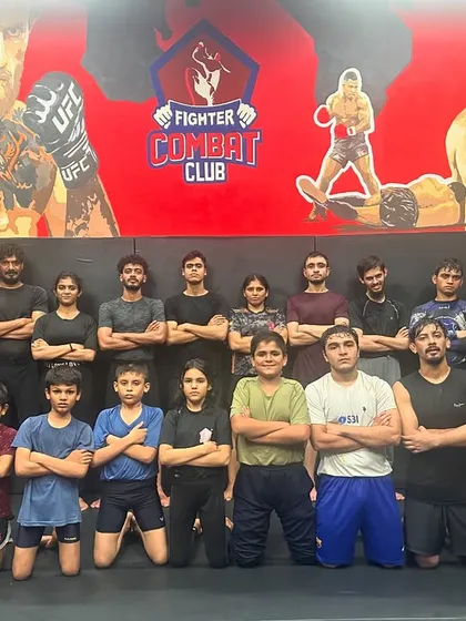 The team with their arms crossed, showing their serious and focused mindset during fight camp. We are a unit, ready for whatever comes next.