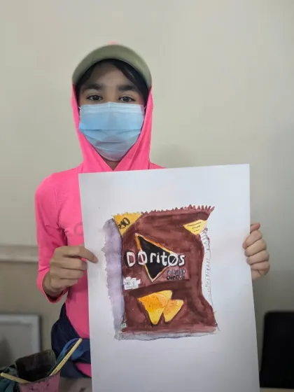 Turning an everyday object into art. Ariya, age 11, did a fantastic job with this realistic watercolor painting of a Doritos bag for her object study class.