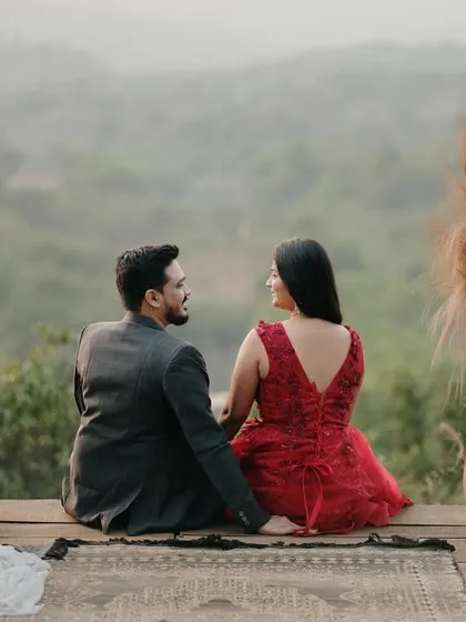 A quiet moment of connection as the couple sits and overlooks the valley, surrounded by romantic decor like candles and a vintage gramophone.