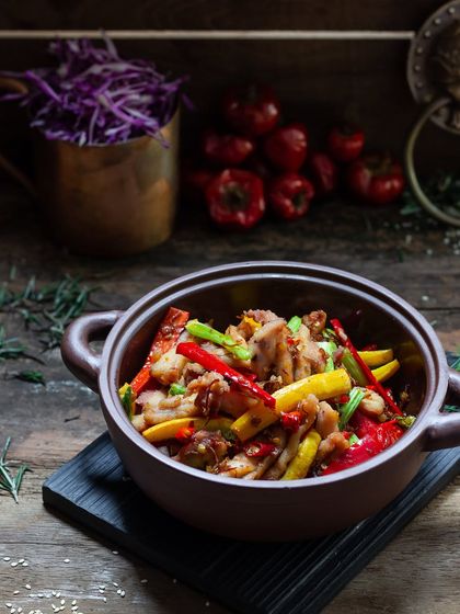 A rustic, dark, and moody shot of a Chinese stir-fry in a clay pot, from my 2018 portfolio.