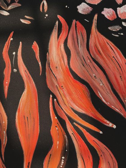 A close-up detail of the abstract fire patterns on the velvet tuxedo. The layering of different shades of orange and red gives the flames a sense of movement.