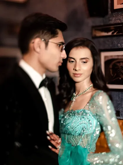 A beautifully composed portrait focusing on the couple's profile and connection. The soft focus and elegant attire give this shot a timeless, romantic quality.