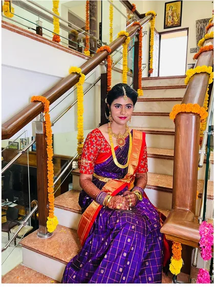 The bride seated on the decorated stairs of her home. These at home ceremonies are so special, and I make sure the makeup is perfect for the intimate setting.