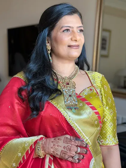 A stunning portrait of a wedding guest. The makeup is tailored to her dusky skin tone, enhancing her features and giving her a radiant, sun-kissed glow.