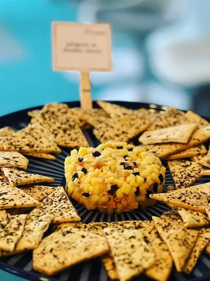 A sweet and savory combination that always works. This pineapple and black olive cheddar cheese ball is served with herb crackers for a delightful bite.
