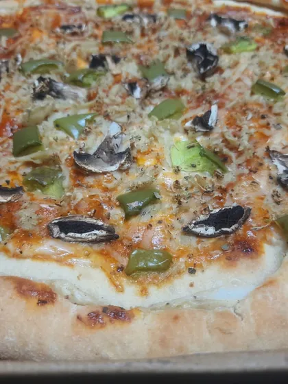A delicious stuffed-crust vegan pizza with mushrooms and green peppers. The crust is filled with my creamy vegan cheese, making every bite a wonderful surprise.