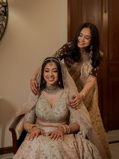 A precious moment with her mother. The bride's soft, glowing makeup is perfect for these heartfelt memories.