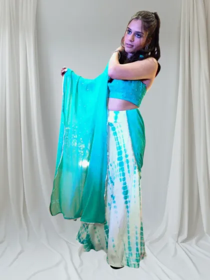 A custom outfit should reflect your personality. This tie-dye skirt and mirror-work halter top was created for a sangeet, designed to be fun, vibrant, and perfect for dancing.