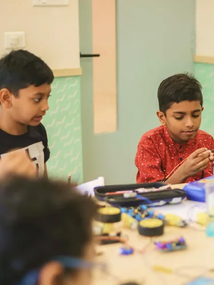 Aethen and a classmate deeply engaged in their robotics project. This image captures the focus and teamwork that our hands-on activities foster.