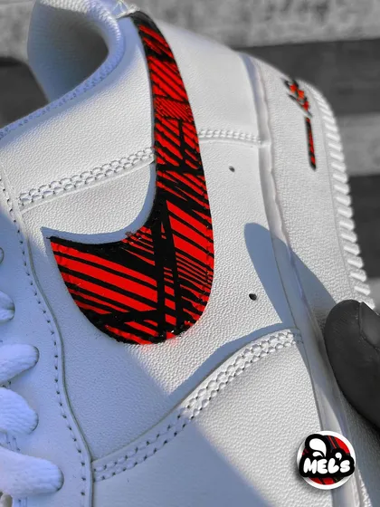 A detailed close-up of the hand-painted geometric pattern inside the Nike swoosh.