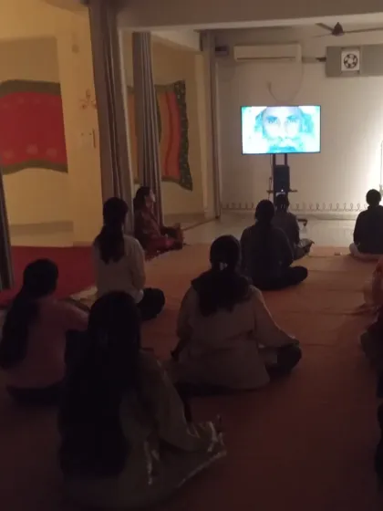 Watching a live satsang during a Purnima gathering. These nights are opportunities to deepen our connection and understanding through the Guru's wisdom.
